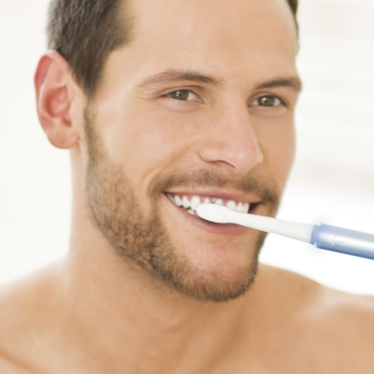 Generic-dentist_SMM_man-brushing-teeth-with-electric-toothbrush.jpg